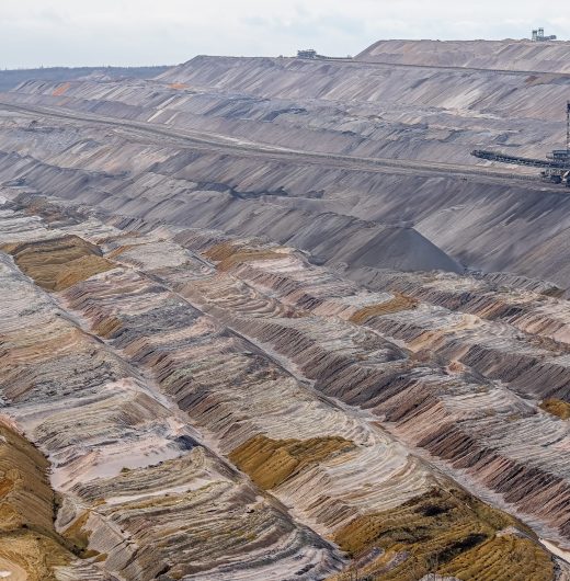 A wide shot of a mining field with an industrial structure